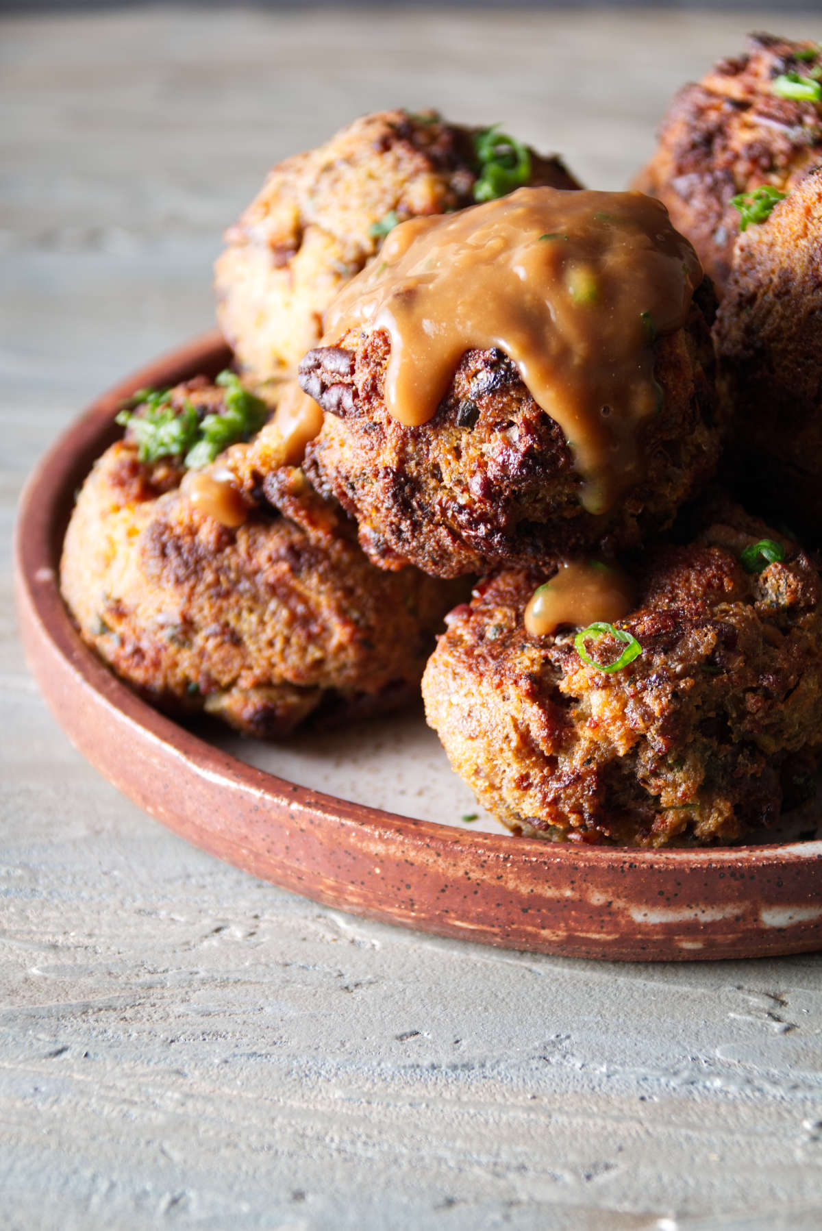 golden brown stuffing balls cooked in the air fryer with gravy on top
