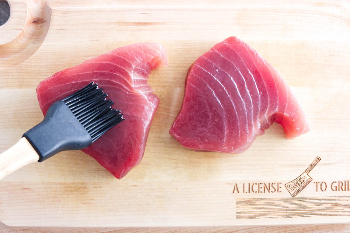 brushing tuna steaks with oil