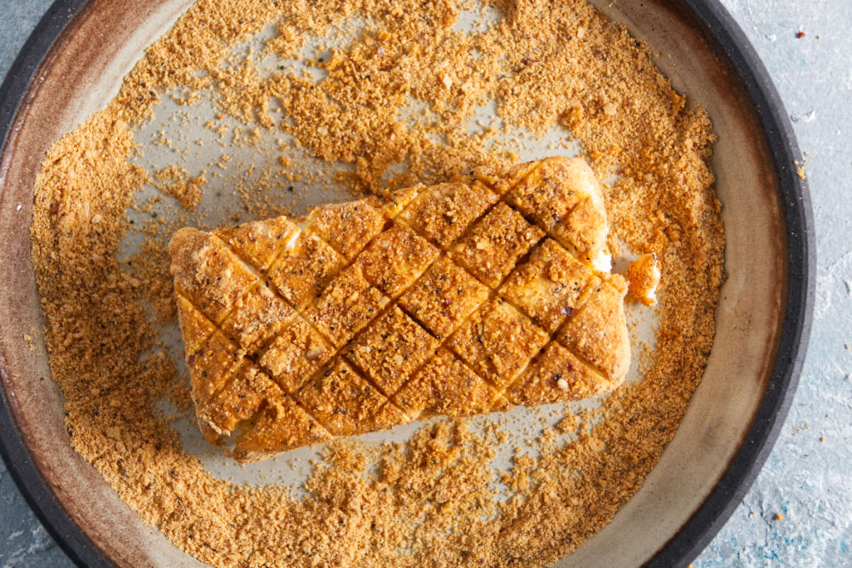 cream cheese being coated in bbq seasoning