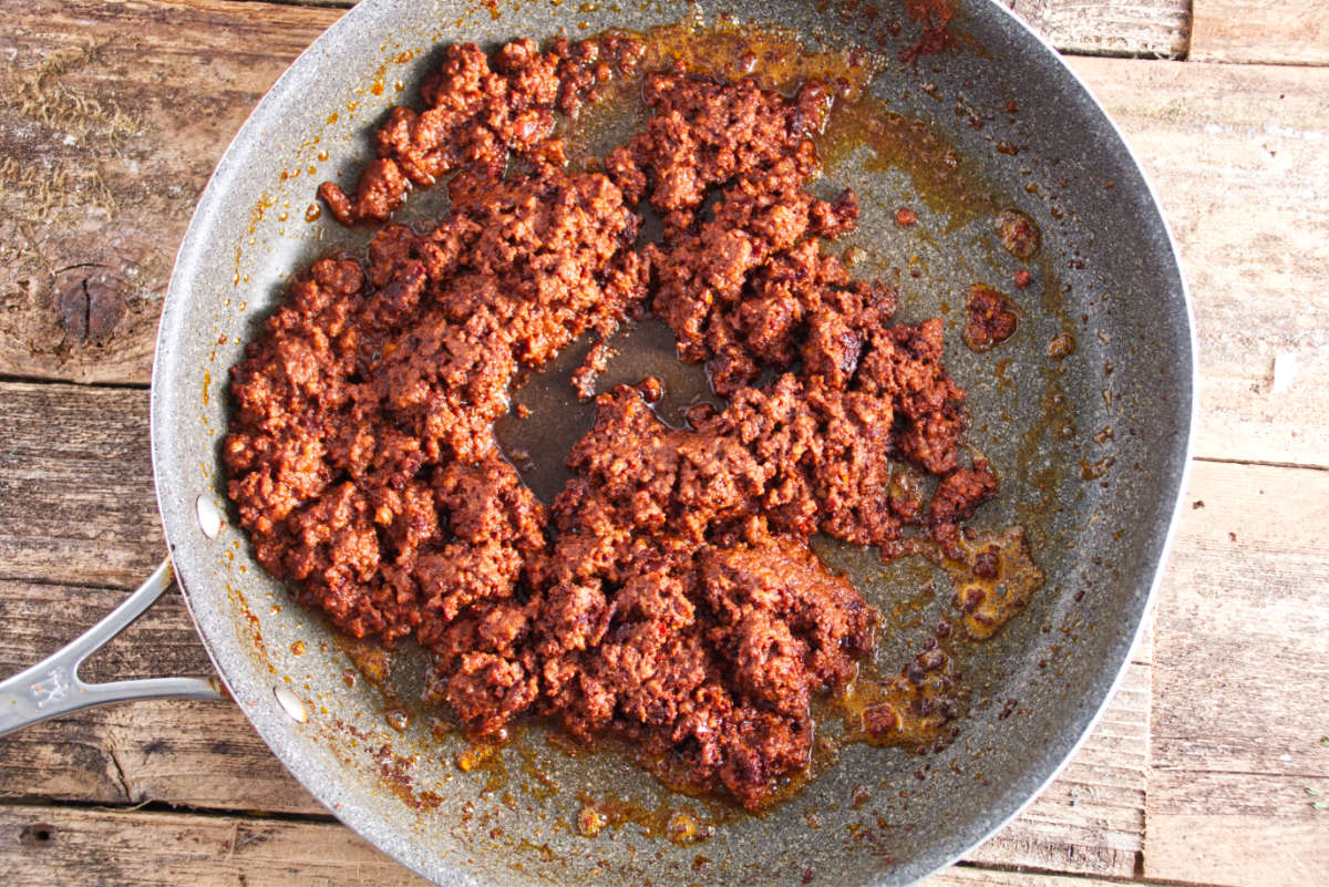 chorizo being cooked in saucepan