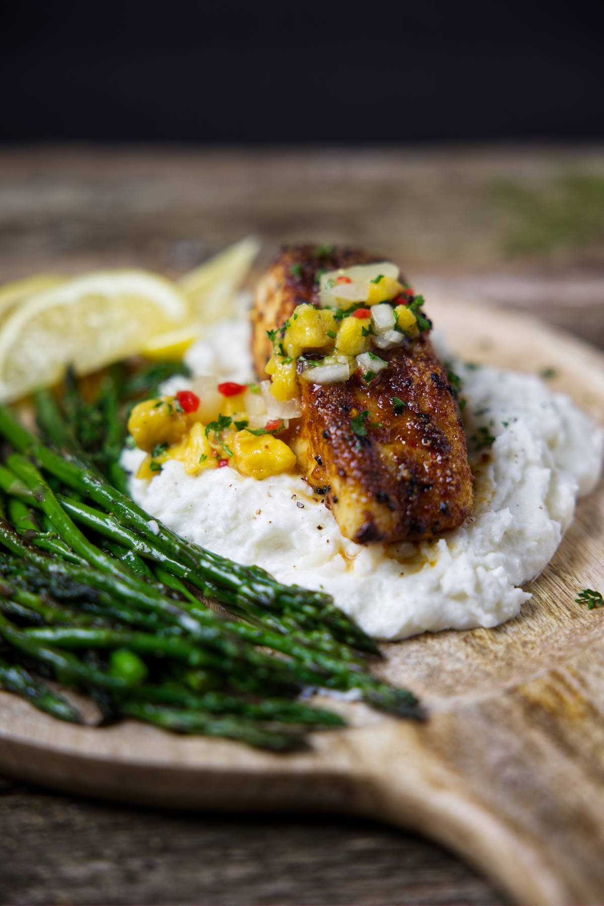 cooked air fryer halibut fillet topped with mango pineapple salsa