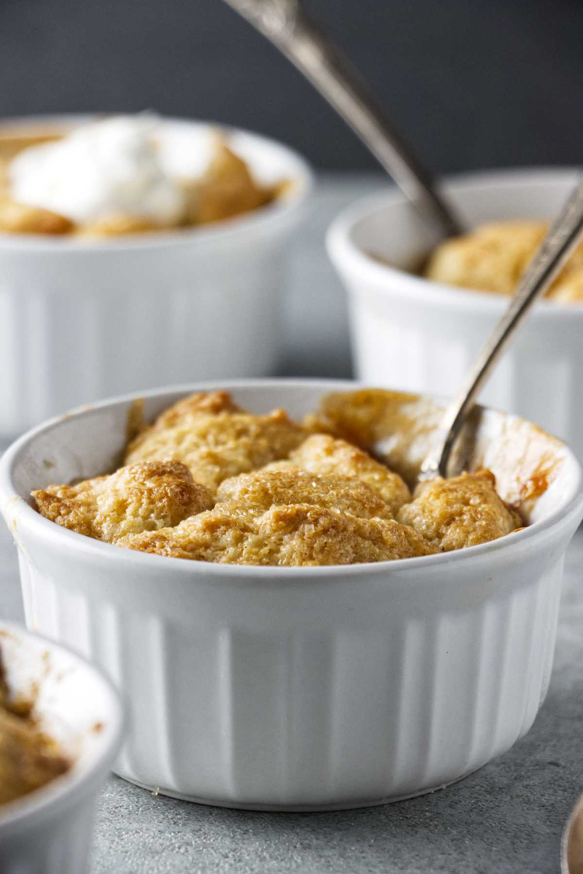 peach cobbler in a ramekin with a fork