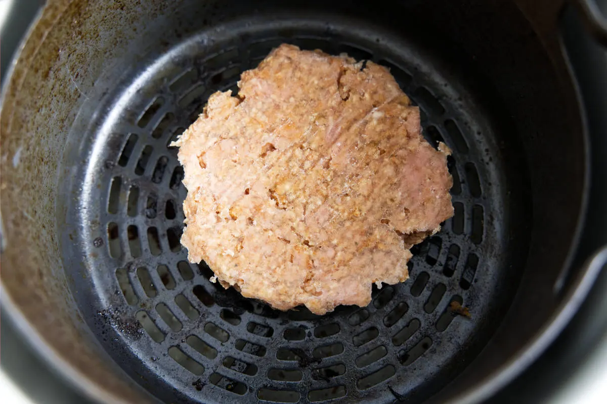 Cooking the air fryer turkey burgers in the air fryer.