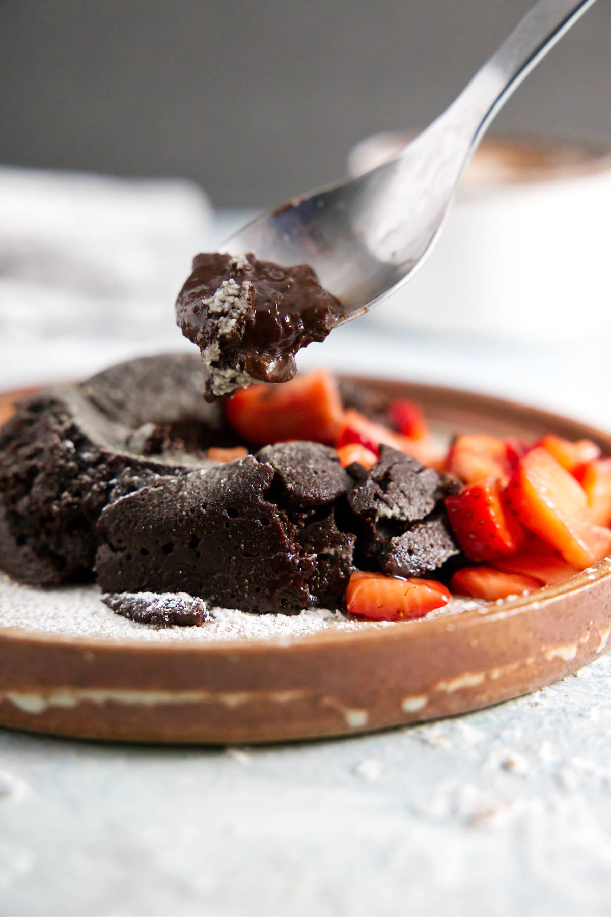 Spoonful of chocolate lava cake with gooey ganache center.