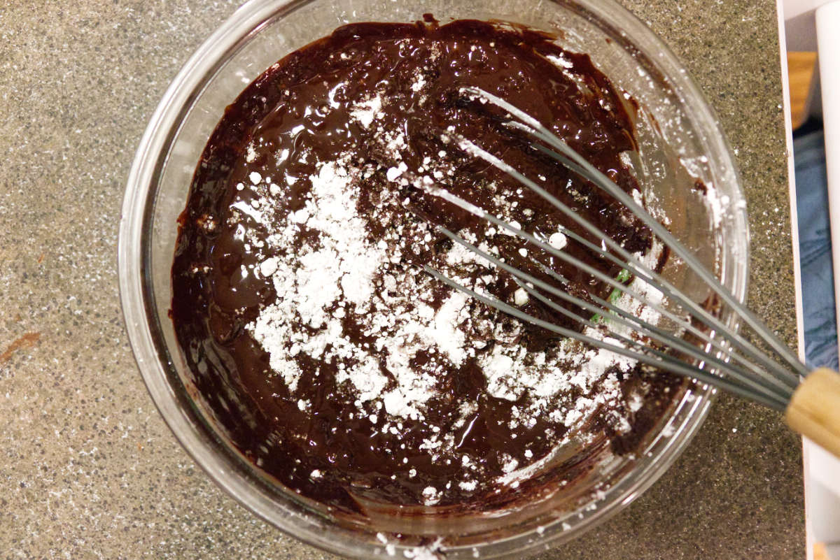 Mixing together ingredients for chocolate lava cake.