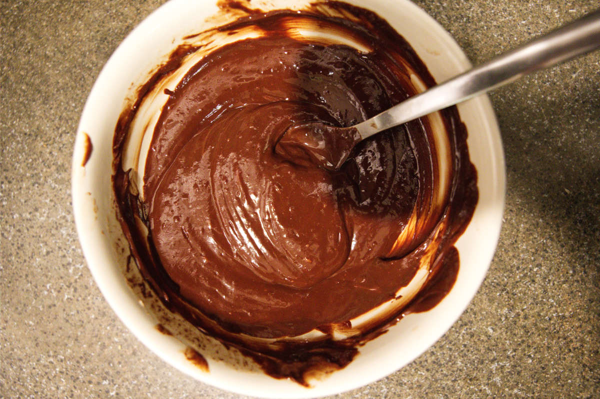 Mixing together chocolate ganache for air fryer mug cake.