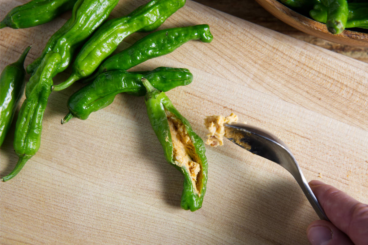 stuffing shishito peppers with cheese filling