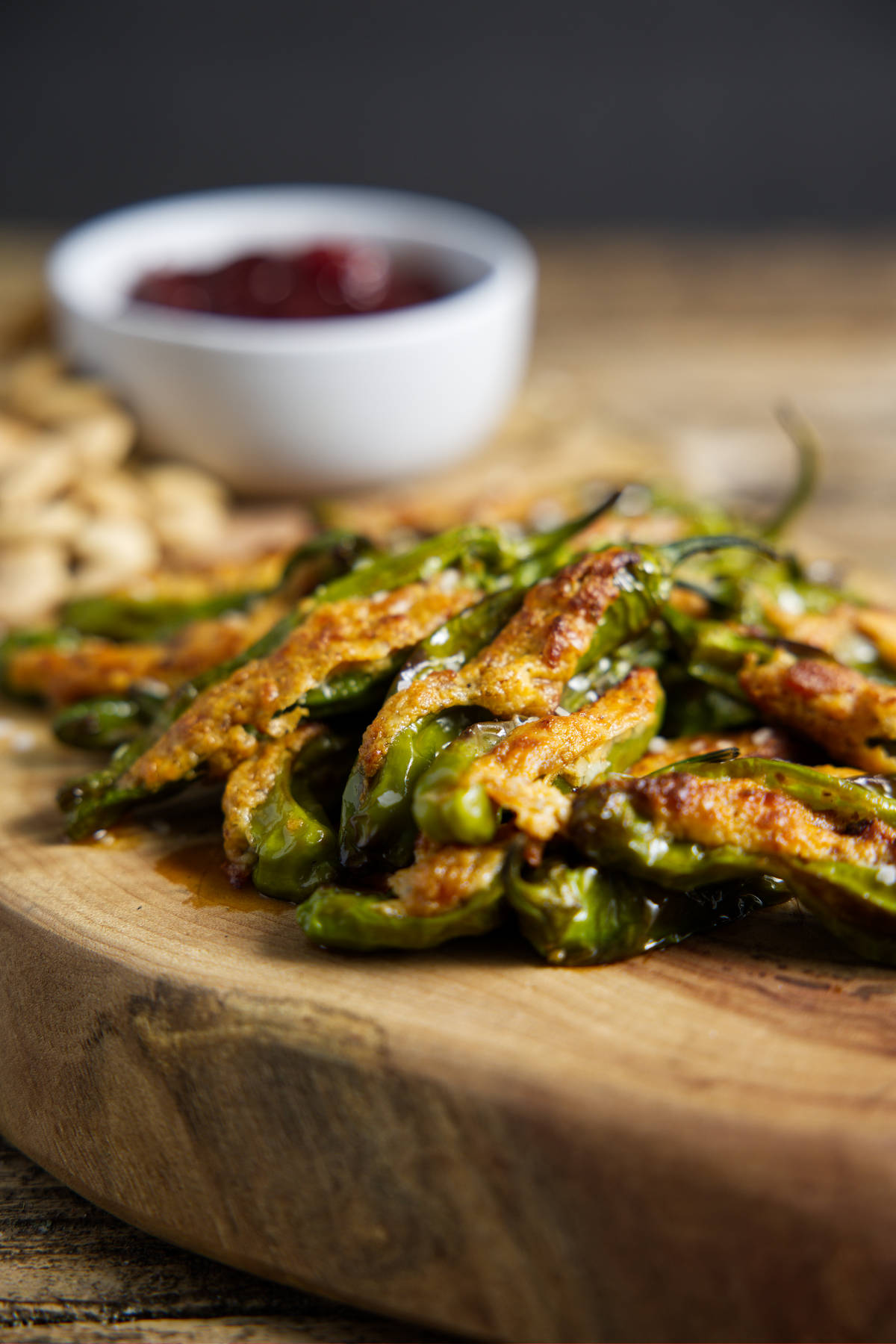 air fryer shishito peppers in a pile on a cutting board