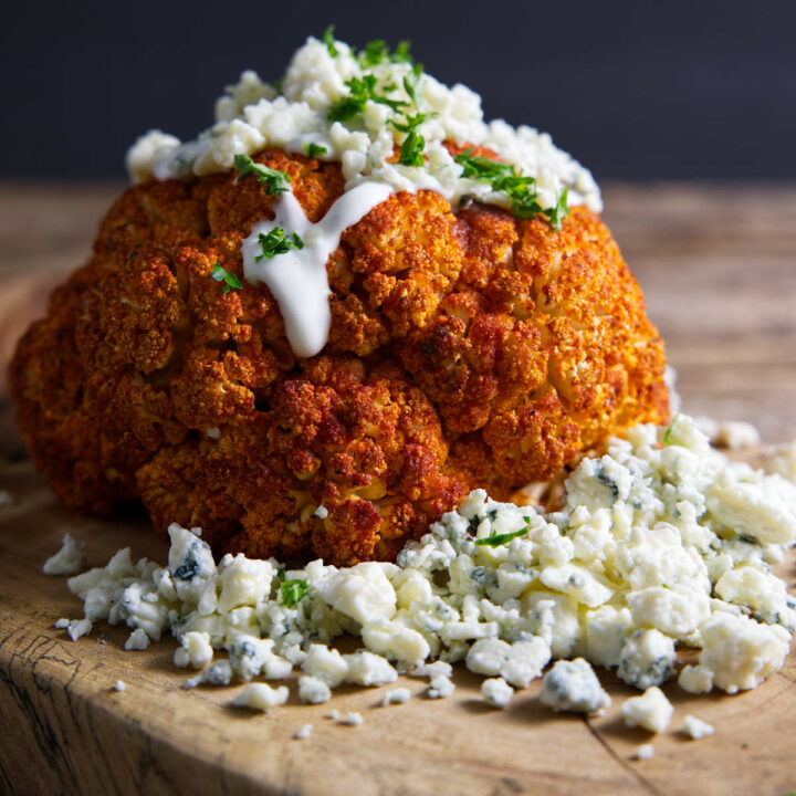 Buffalo marinated cauliflower with blue cheese crumbles and dressing.