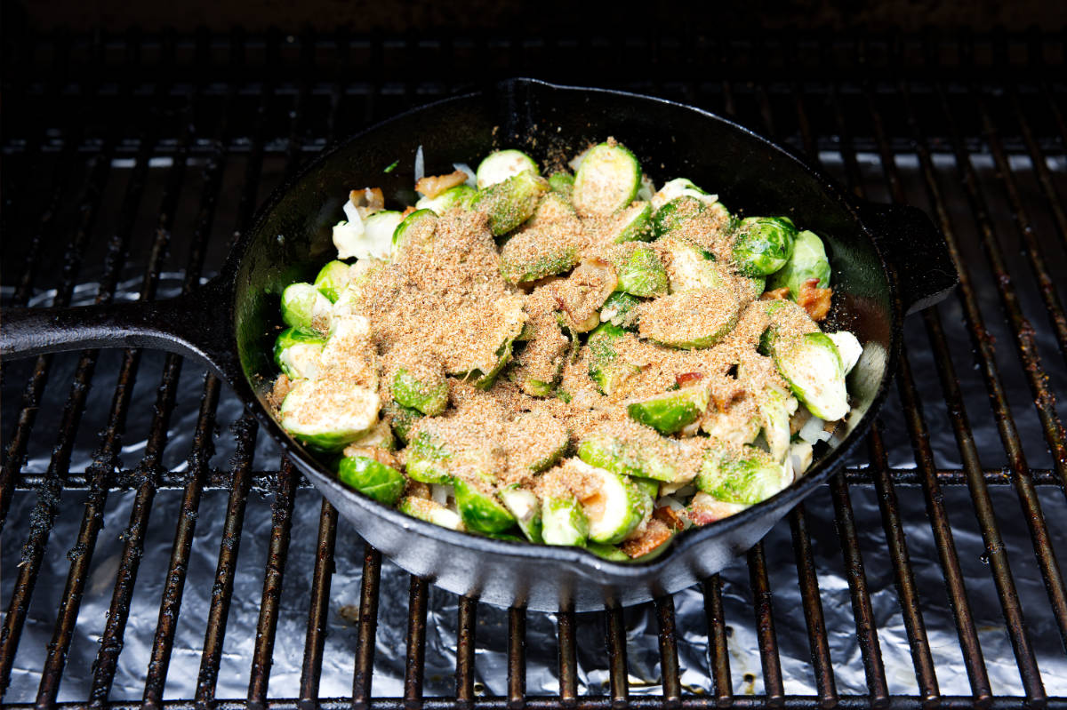 brussels sprouts in a skillet with seasoning sprinkled on top