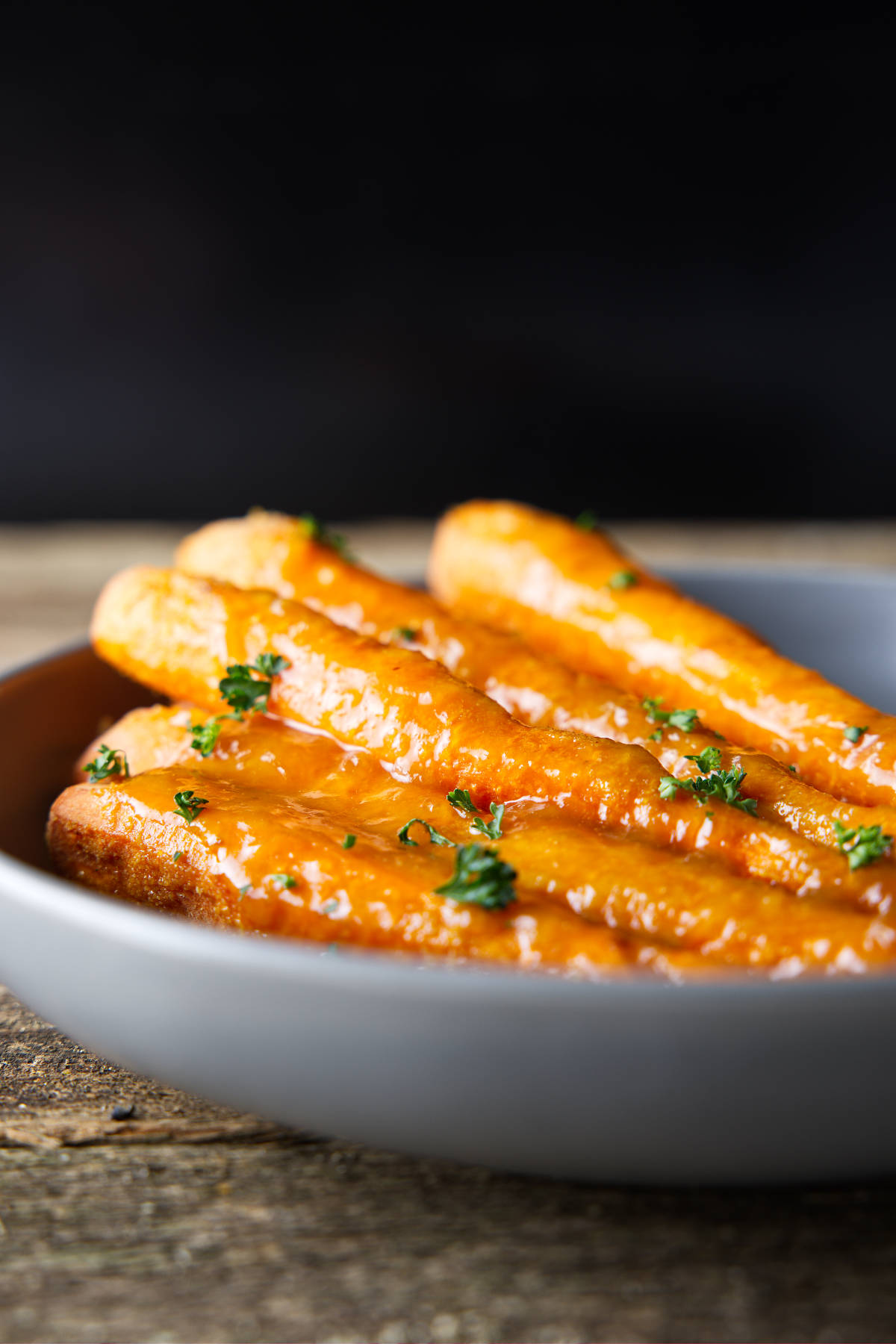 Glazed smoked carrots in a bowl.