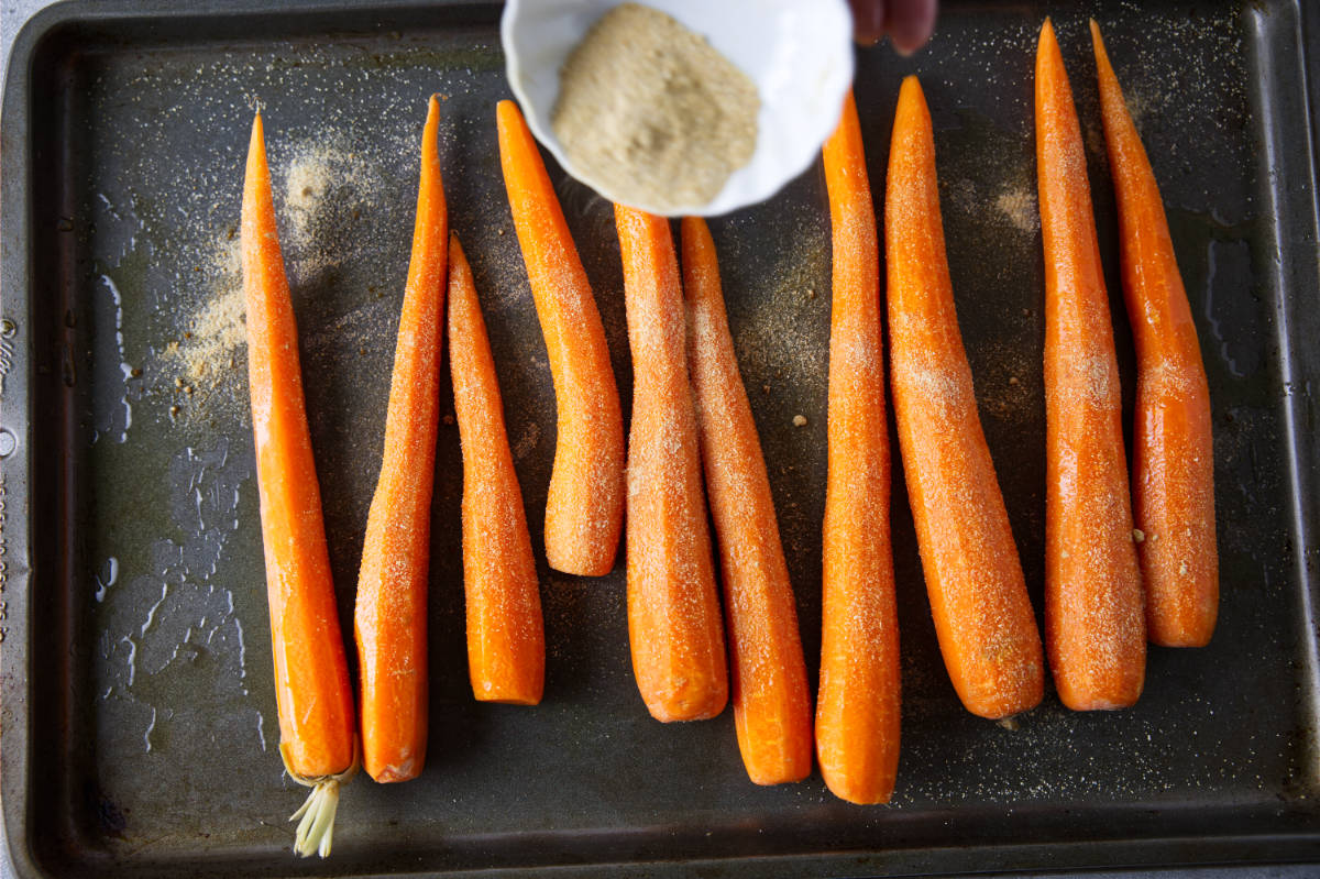 Seasoning the smoked carrots.