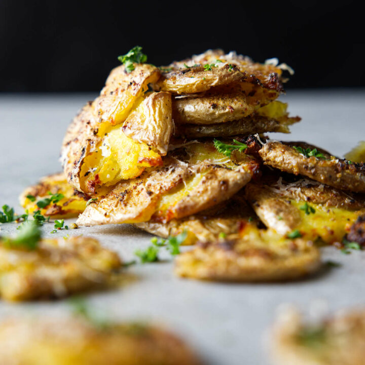 smashed baby potatoes with crispy edges stacked in pile