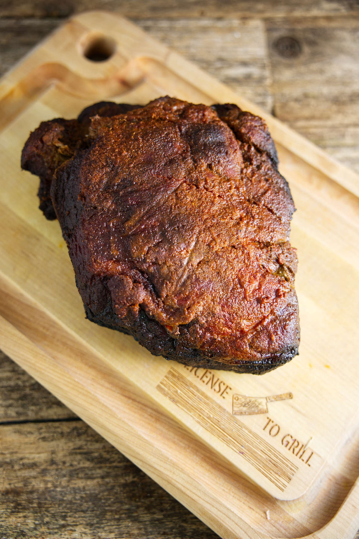 Smoked pork shoulder on butcher block.