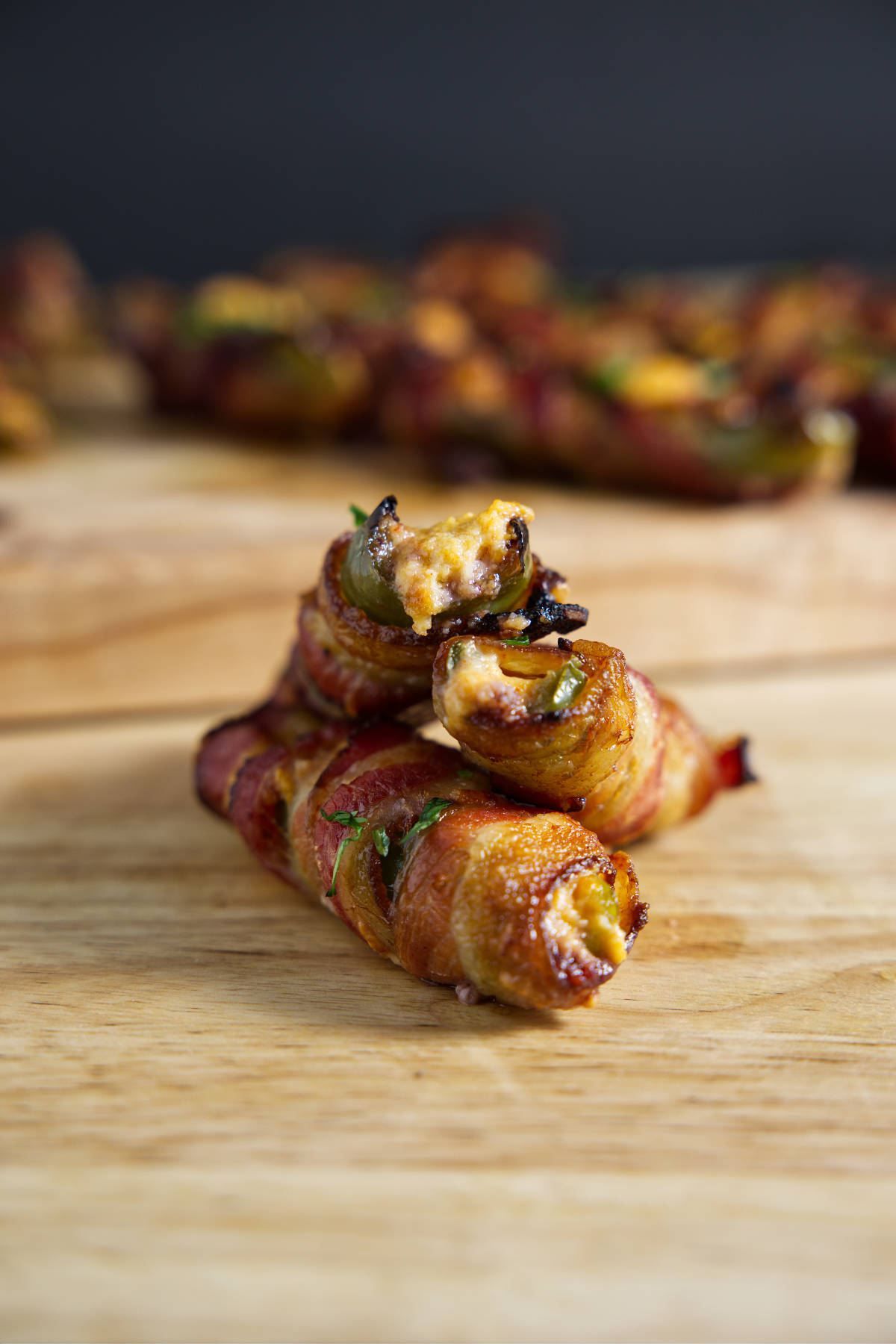 Several jalapeño poppers on a cutting board, ready for eating!