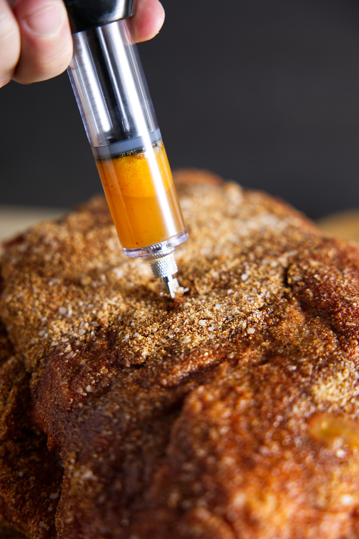 Injecting marinade into seasoned meat.