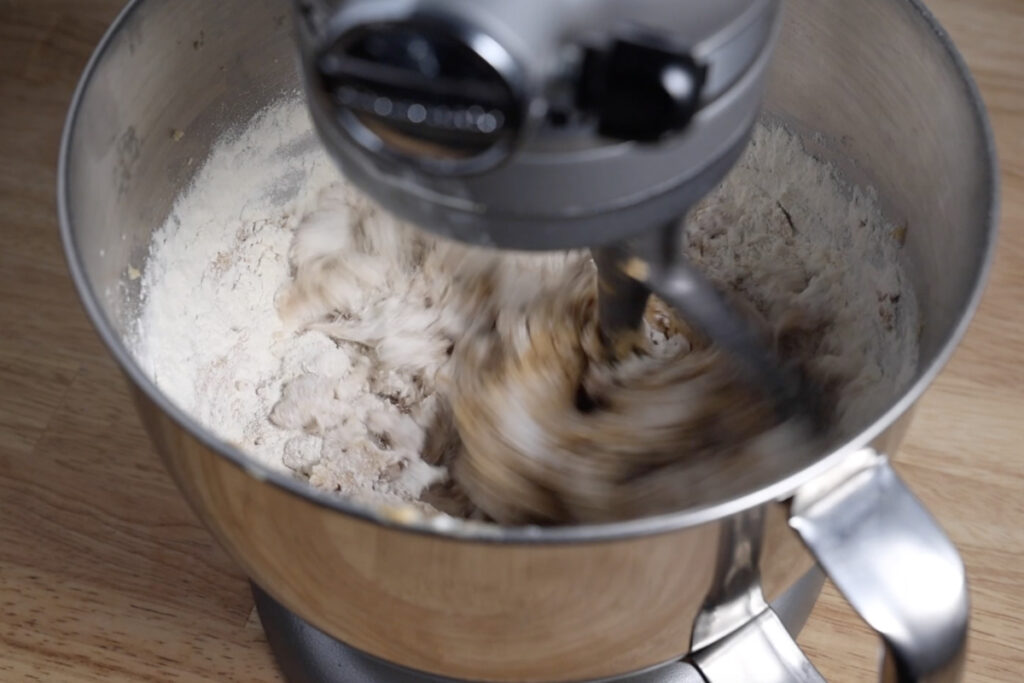 Mixing flour into cookie dough.