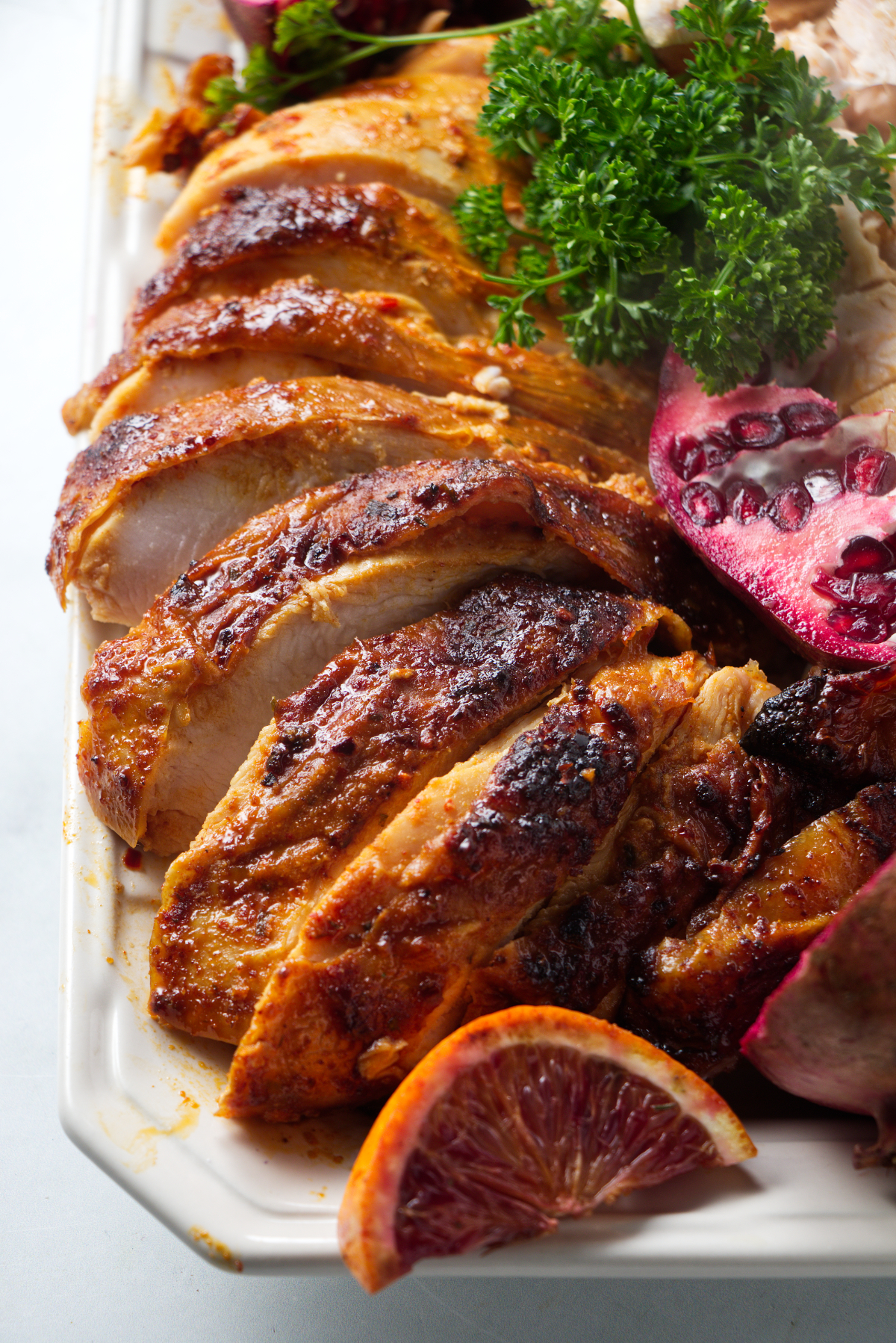 Sliced turkey served on a platter with garnish.