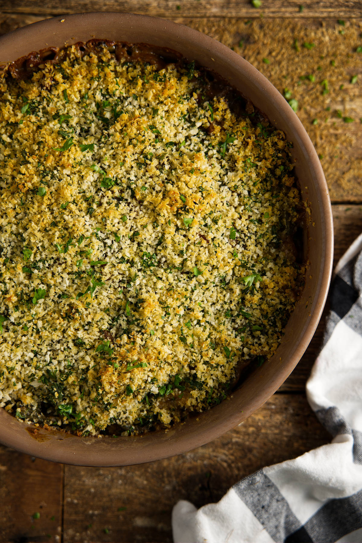 Overhead of green bean casserole, topped with an herb breadcrumb mixture and smoked until golden brown.