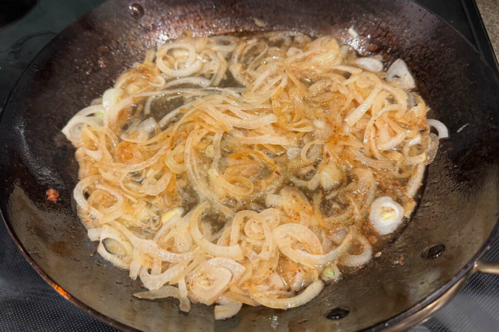 Sauteing onions in a fry pan.