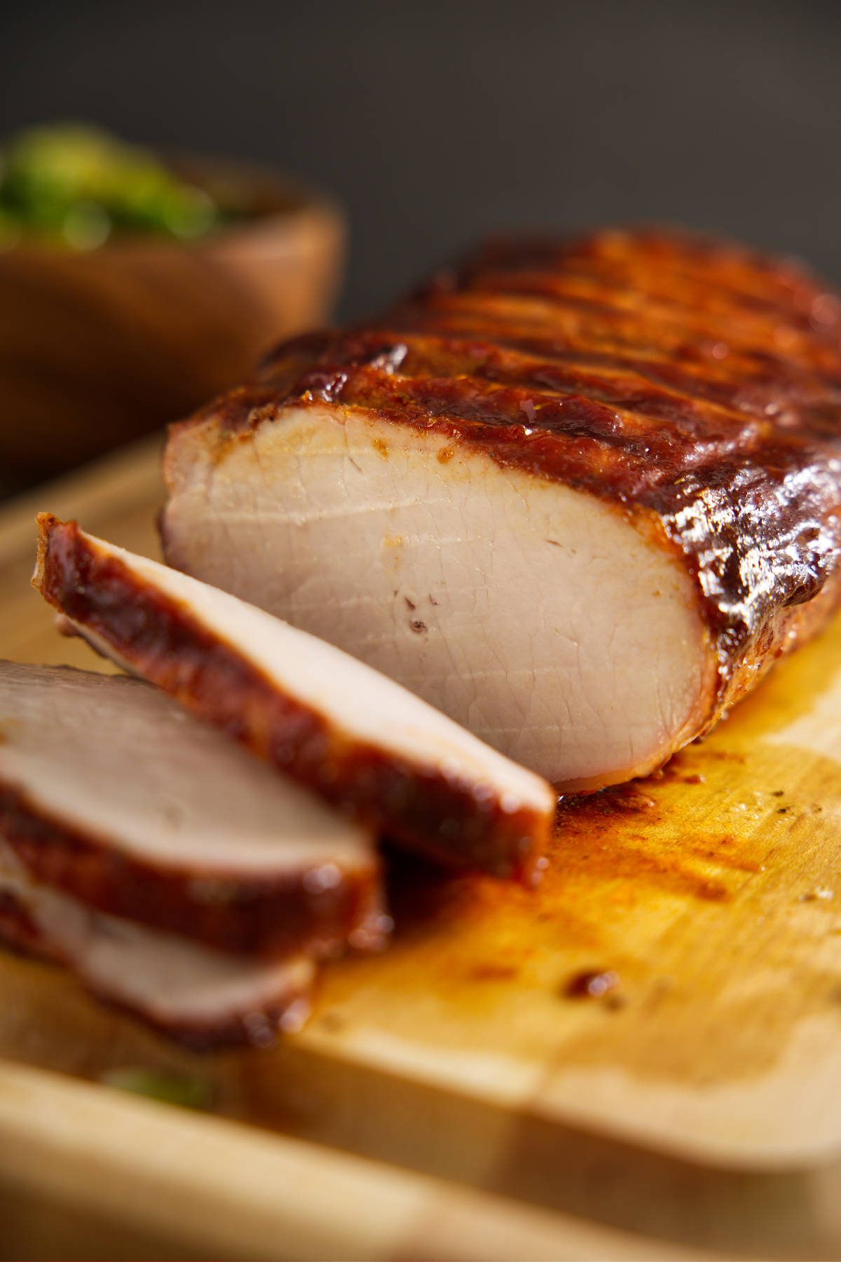 How to BBQ pork loin, whole pork loin sliced on cutting board.