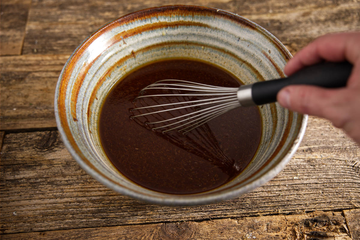 Mixing together wet ingredients for pork marinade.