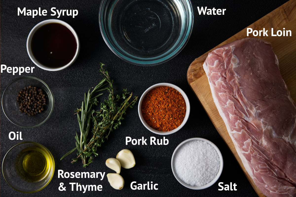 Ingredients for pork loin brine laid out on a charcoal black background.