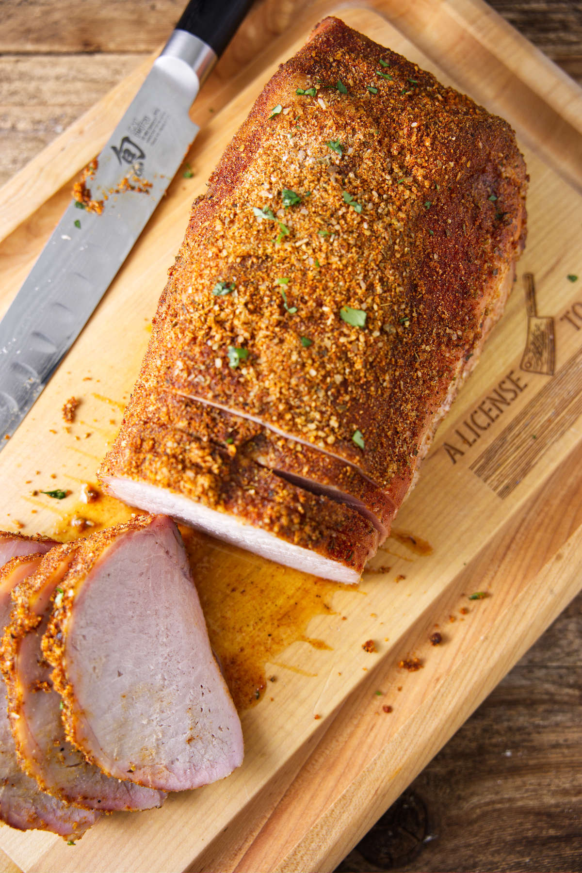 Sliced smoked pork loin on cutting board.