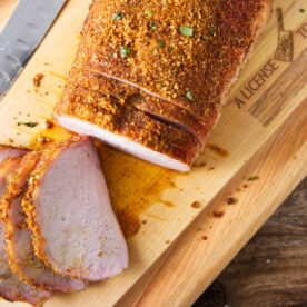 Sliced pork loin on cutting board.