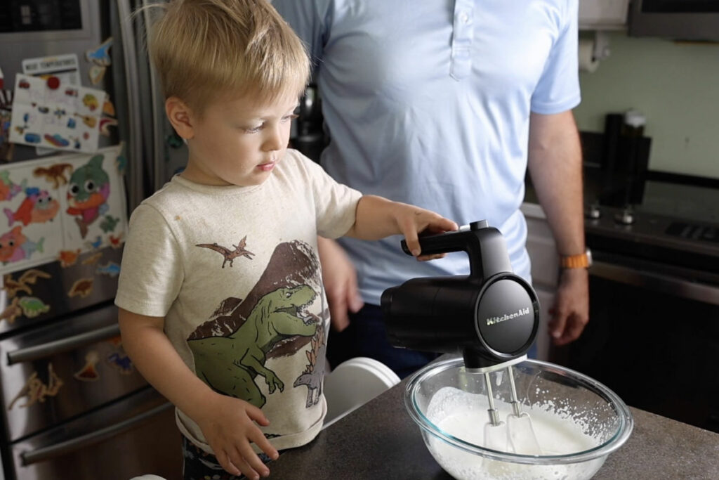 Using hand mixer to make whipped cream.