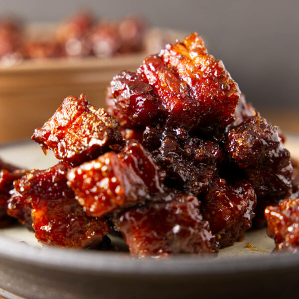 Pile of pork belly burnt ends on a plate.