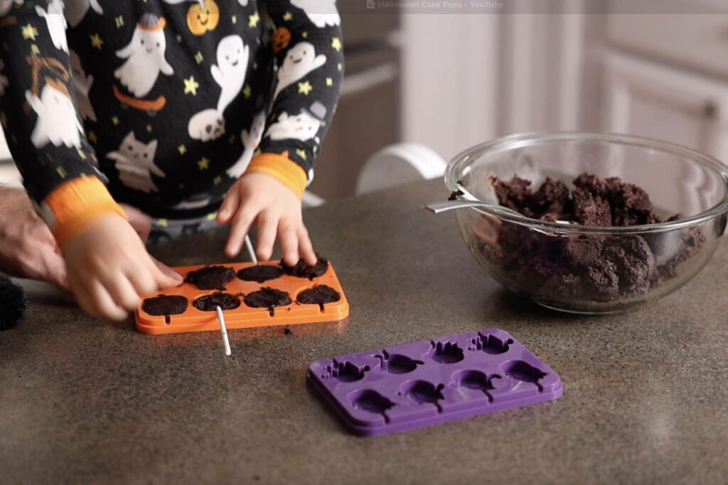 Molding cake pops and adding a stick.