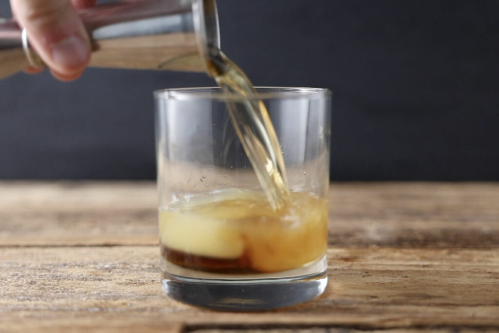 Pouring bourbon in cocktail class.