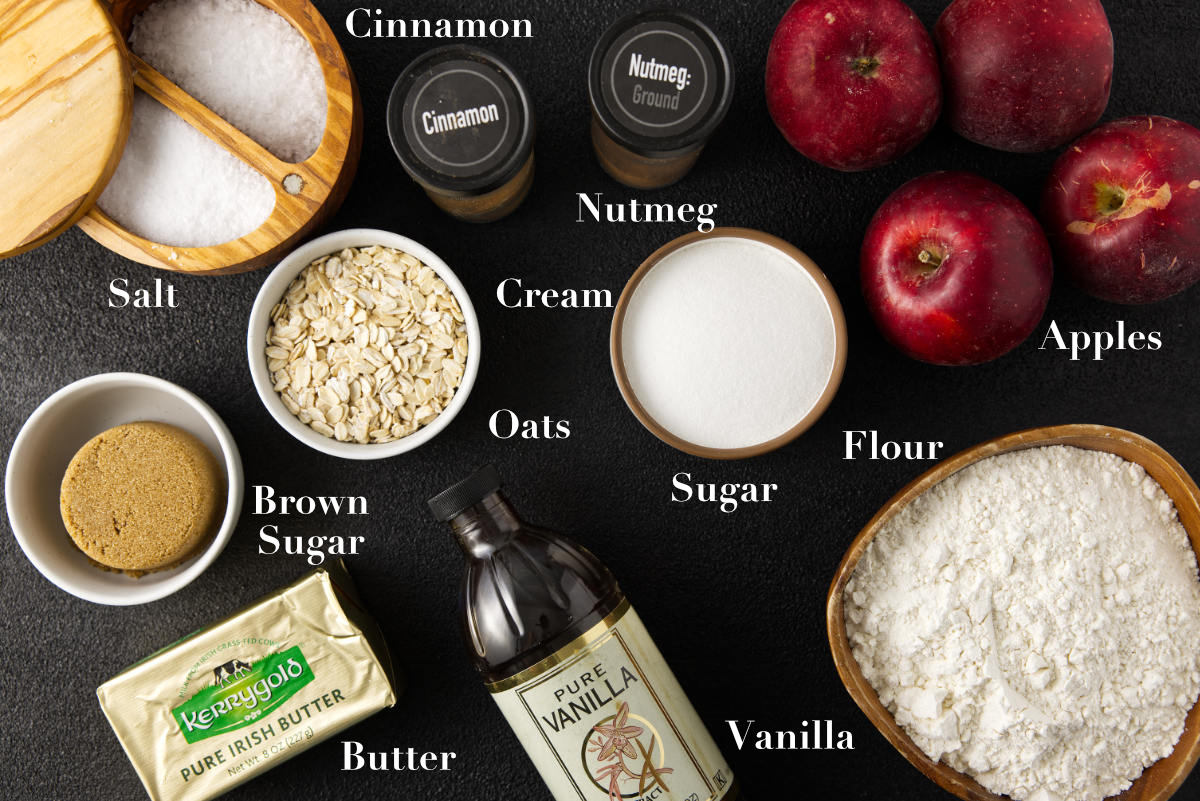 Ingredients for apple crisp bars laid out on a black counter.