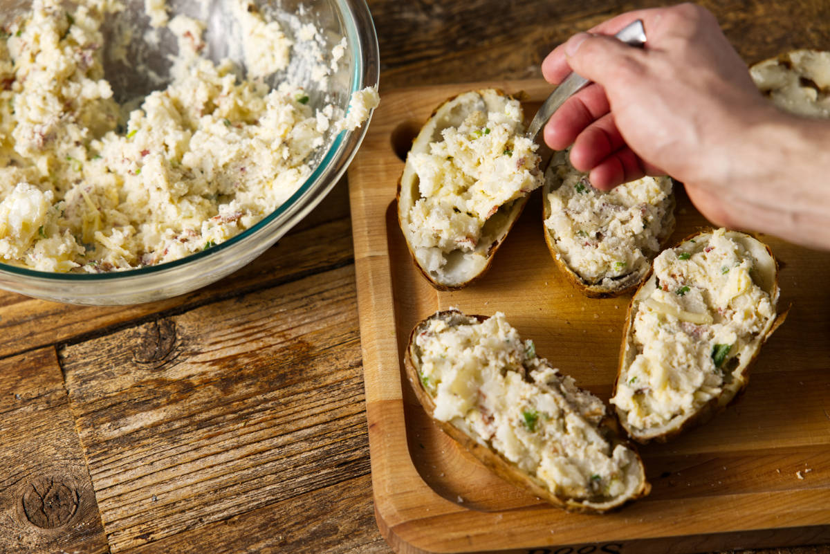 Filling potatoe skins for twice baked potatoes.