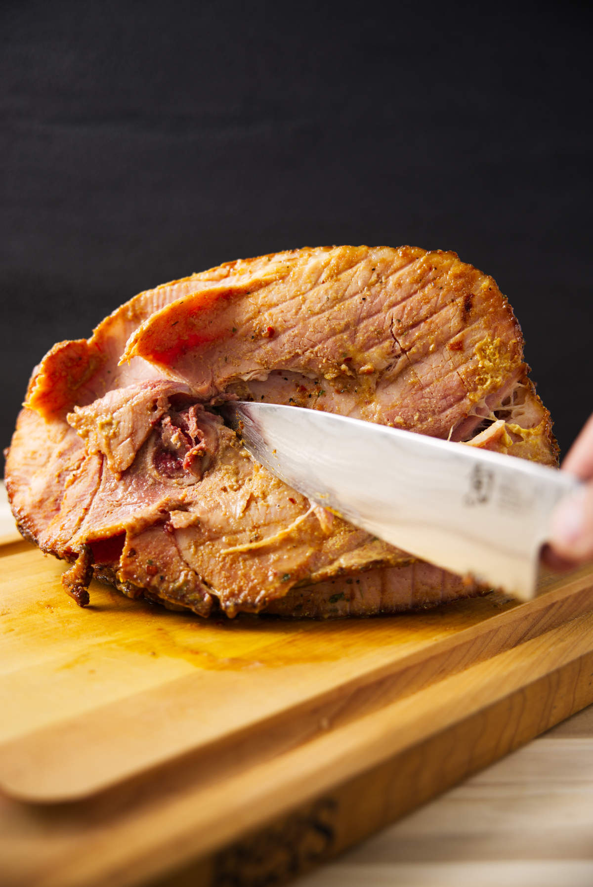 Cutting bone out of spiral sliced ham.