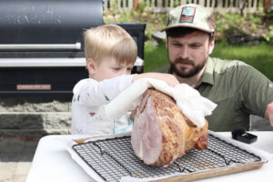 Patting dry the spiral cut ham.
