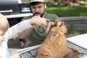 Placing thermometer in spiral cut ham.