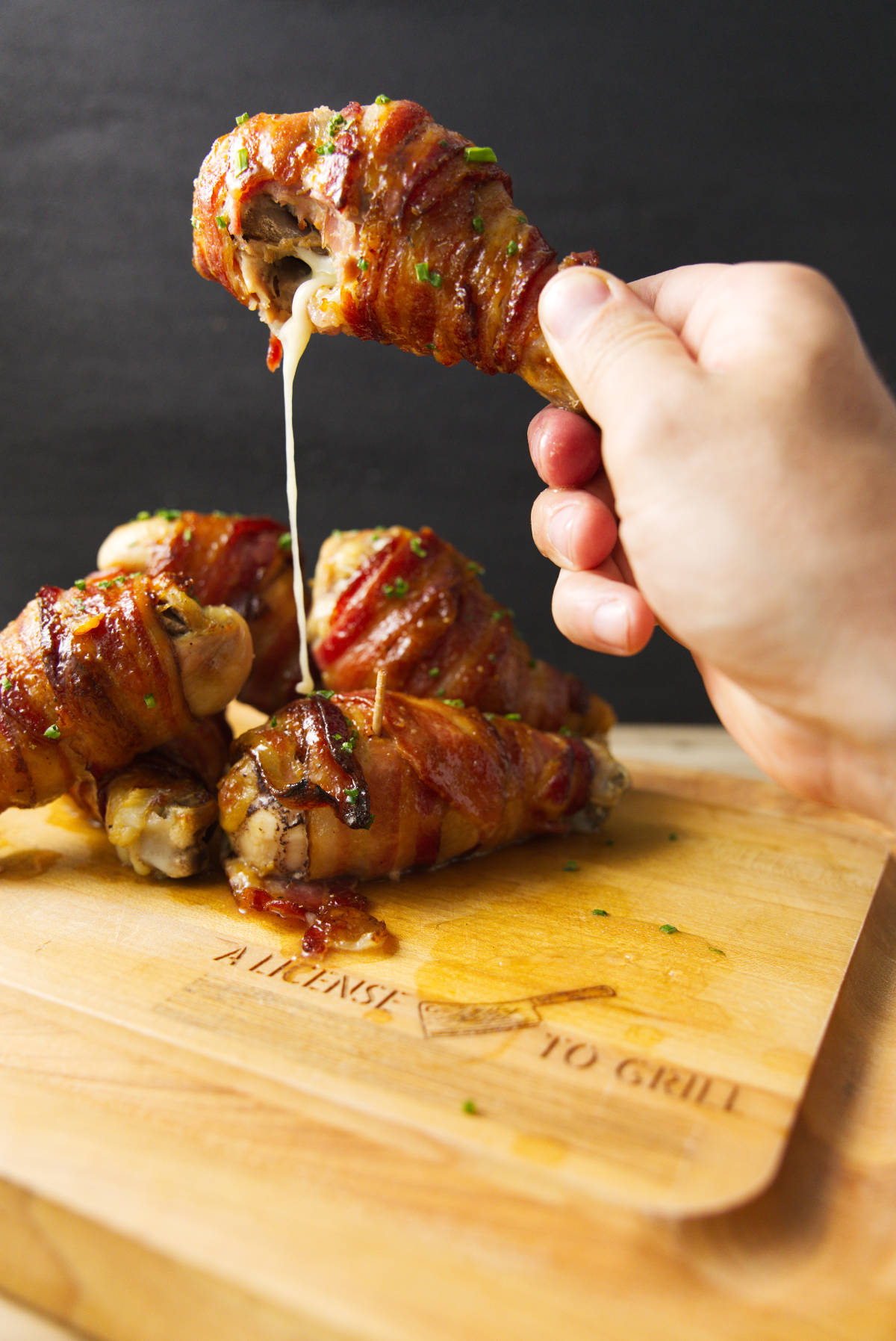 Cheese oozing out of a Traeger smoked stuffed chicken leg.