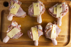 Cheese and ham stuffed in butterflied chicken leg.