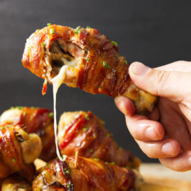 Cheese oozing out of Traeger stuffed chicken leg after taking a bite.