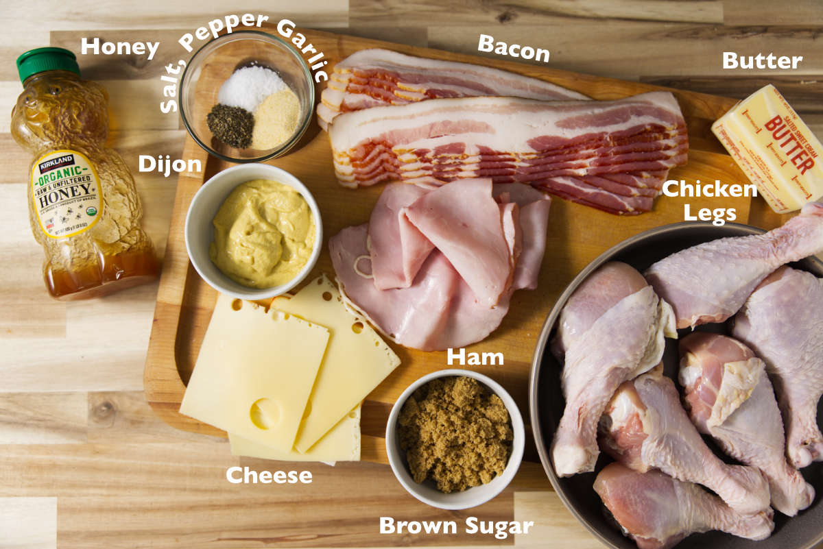 Ingredients for stuffed chicken legs spread out on cutting butcher block.
