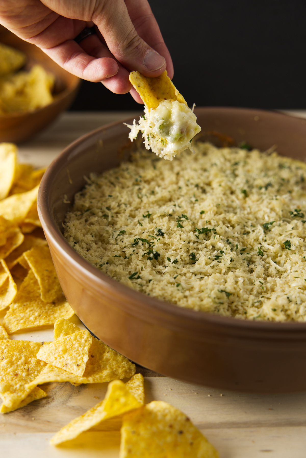 Dipping chip in smoked jalapeño popper cheese dip.