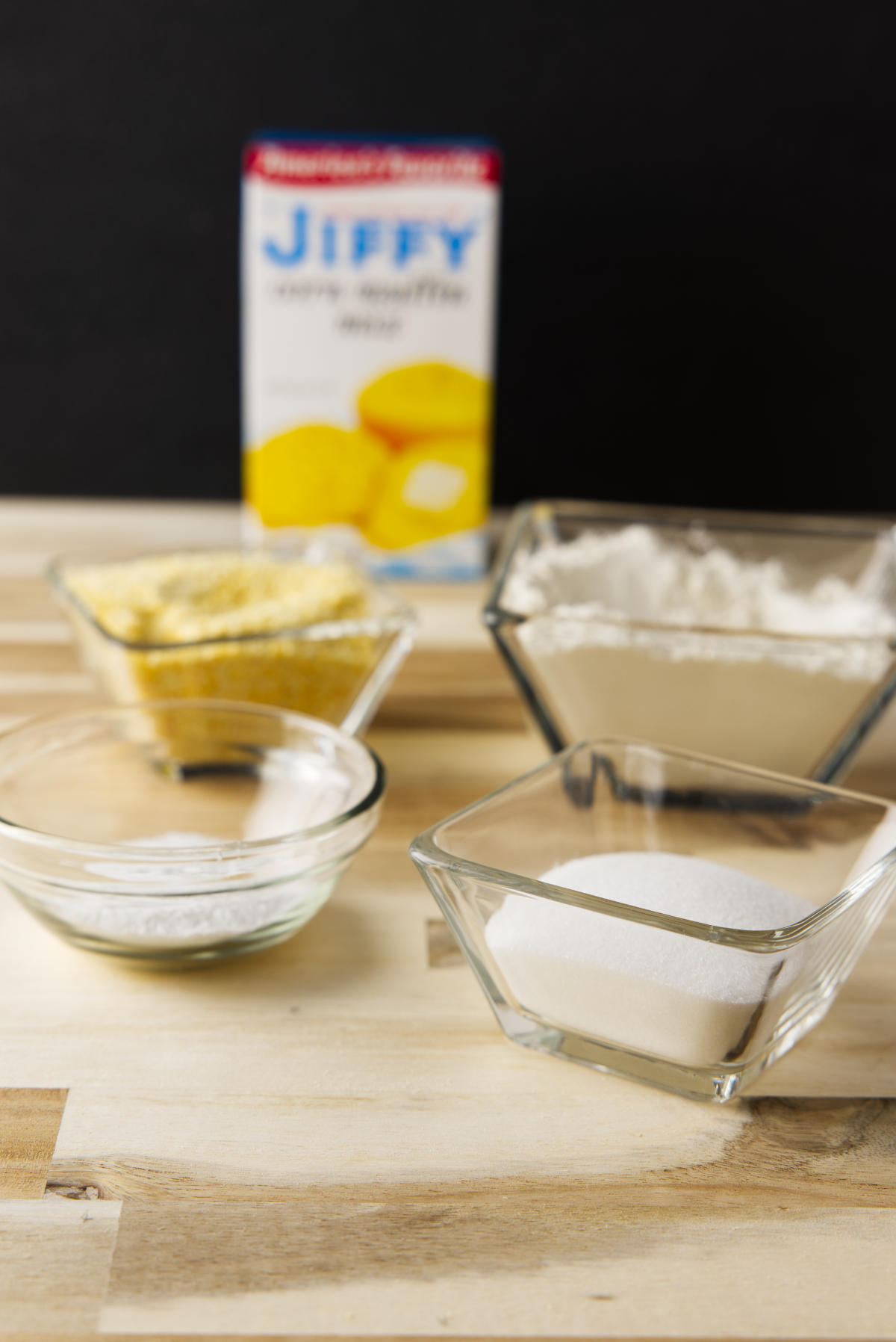 Ingredients to substitute with boxed Jiffy corn muffin mix in the background.