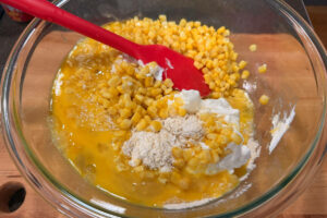 Adding wet ingredients to mixing bowl.