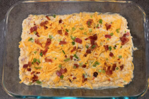 Corn casserole in a glass baking dish.