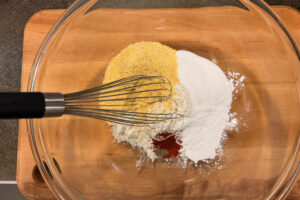 Mixing together dry ingredients for corn casserole.