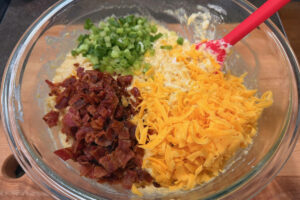 Mixing bowl full of all of the ingredients for smoked corn casserole.