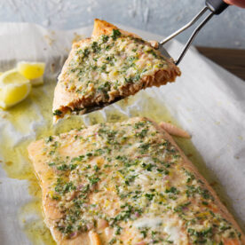 Slice of pellet grill salmon fillet being served with a fish turner.