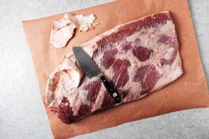 Trimming the fat off a brisket.